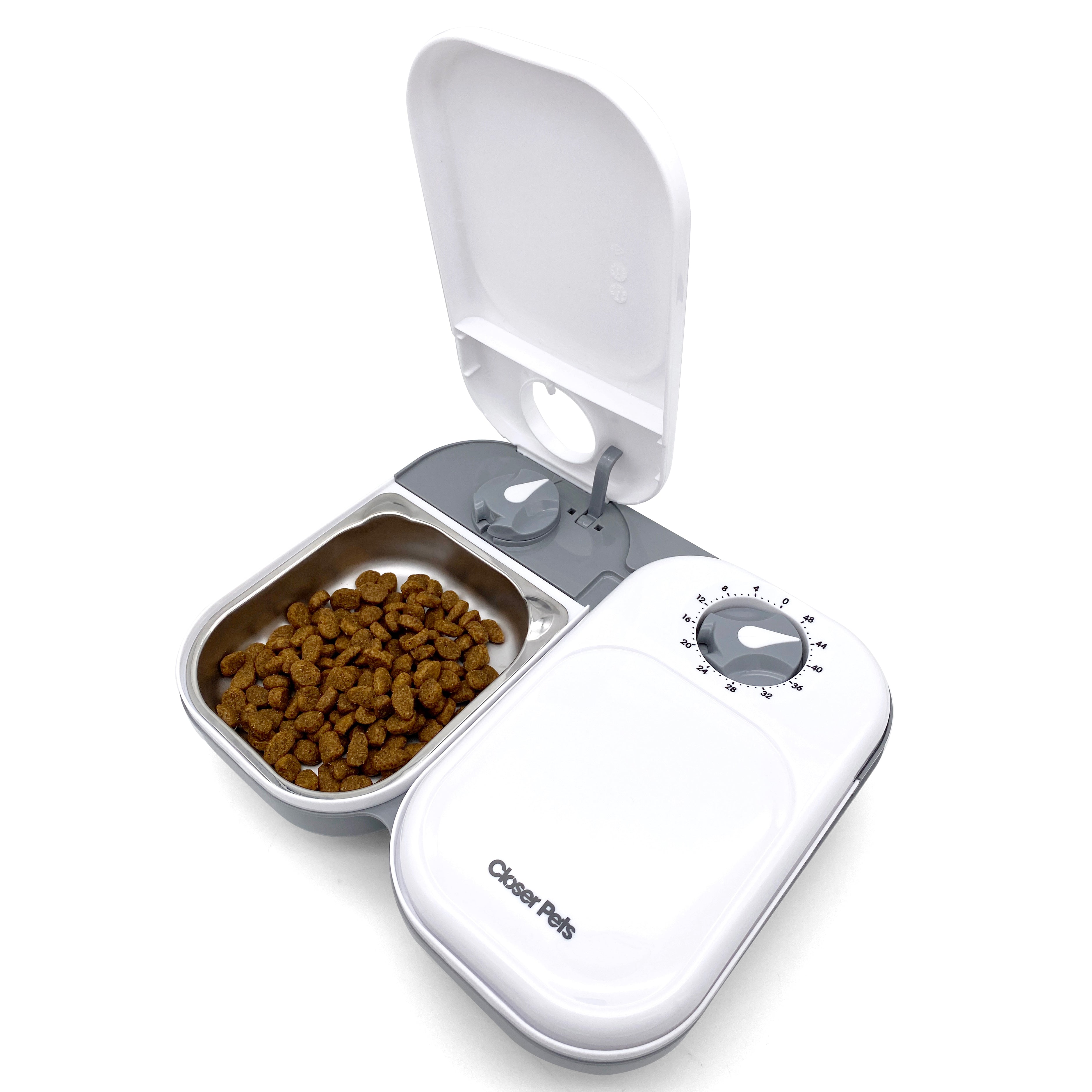 An automatic pet feeder with a grey body and a white lid, showing a stainless steel bowl filled with pet food inside.
