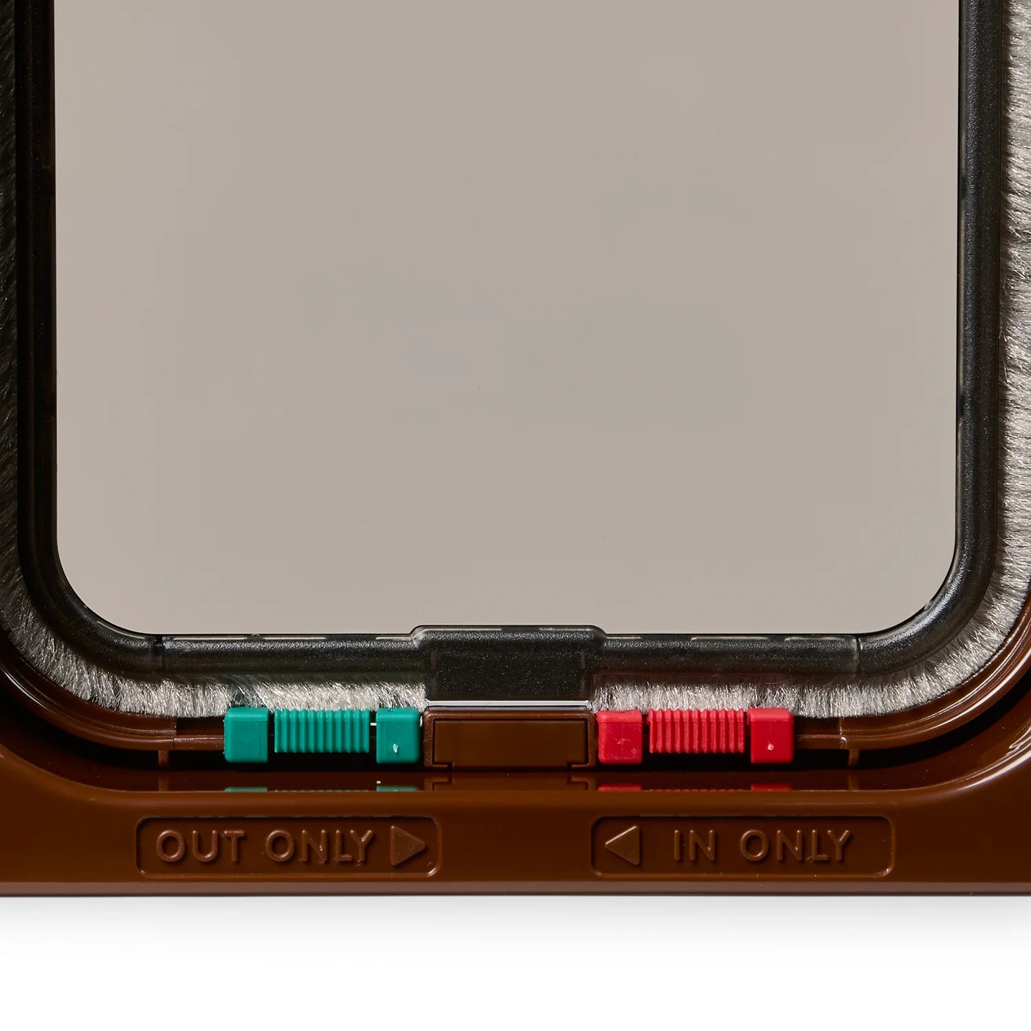 Close-up of the brown cat flap frame with 'IN ONLY' and 'OUT ONLY' labels on a white background