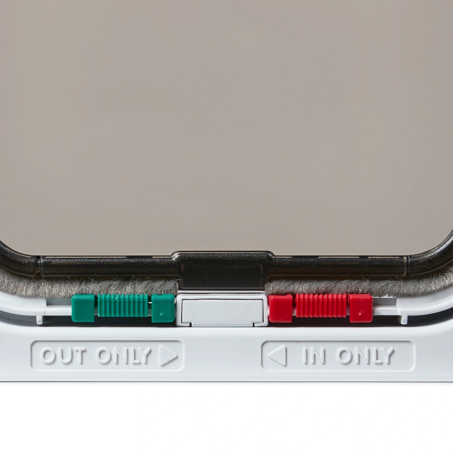 Close-up of the bottom of the white Cat Mate cat flap with 'OUT ONLY' and 'IN ONLY' labels on a white background