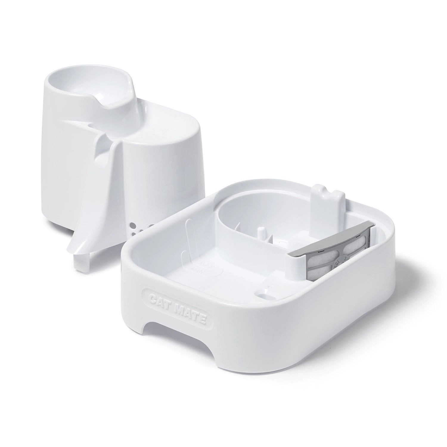 A view of the separated parts of the fountain displaying in the base where the grey filter cartridge is located, in addition to min min/max water levels, on a white background