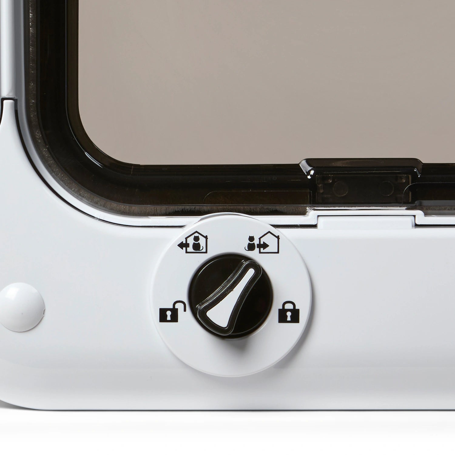 Close-up of a white and black manual locking dial which controls the locks on the white frame and the clear plastic panel