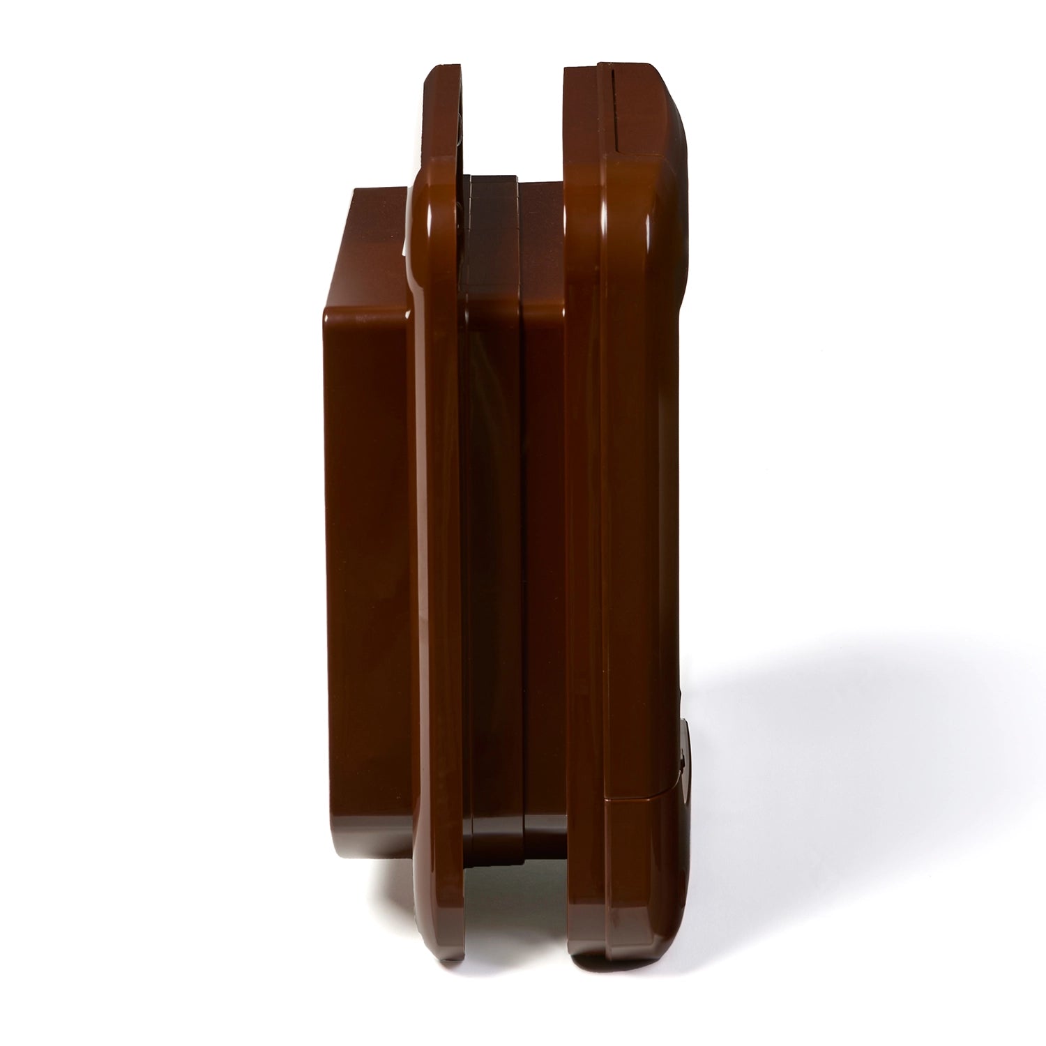 A side on view of the brown cat flap for installation into walls and doors as it is self lining up to two inches