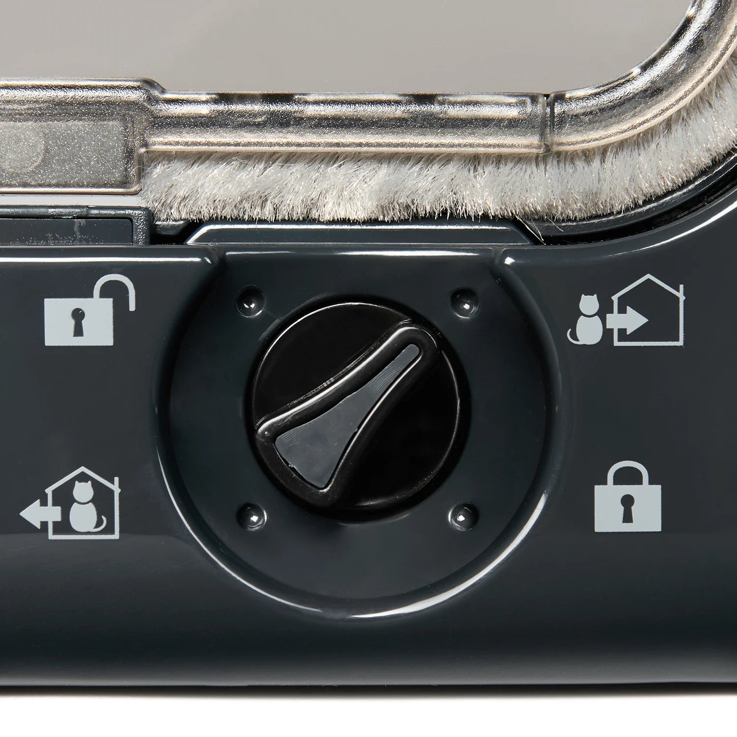 Close up view of the cat flap by Cat Mate's manual black locking dial which displays the four different locking options that the door is equipped to offer users.