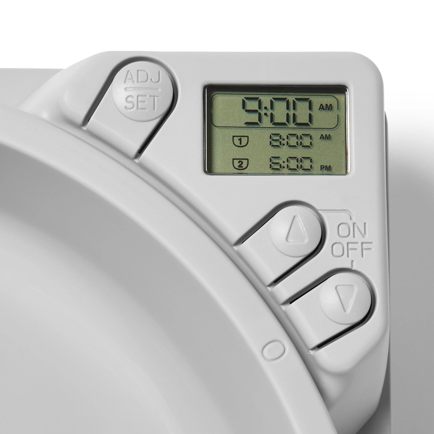 Digital timer with time display on the white three meal automatic pet feeder for cats and small dogs on a a white background