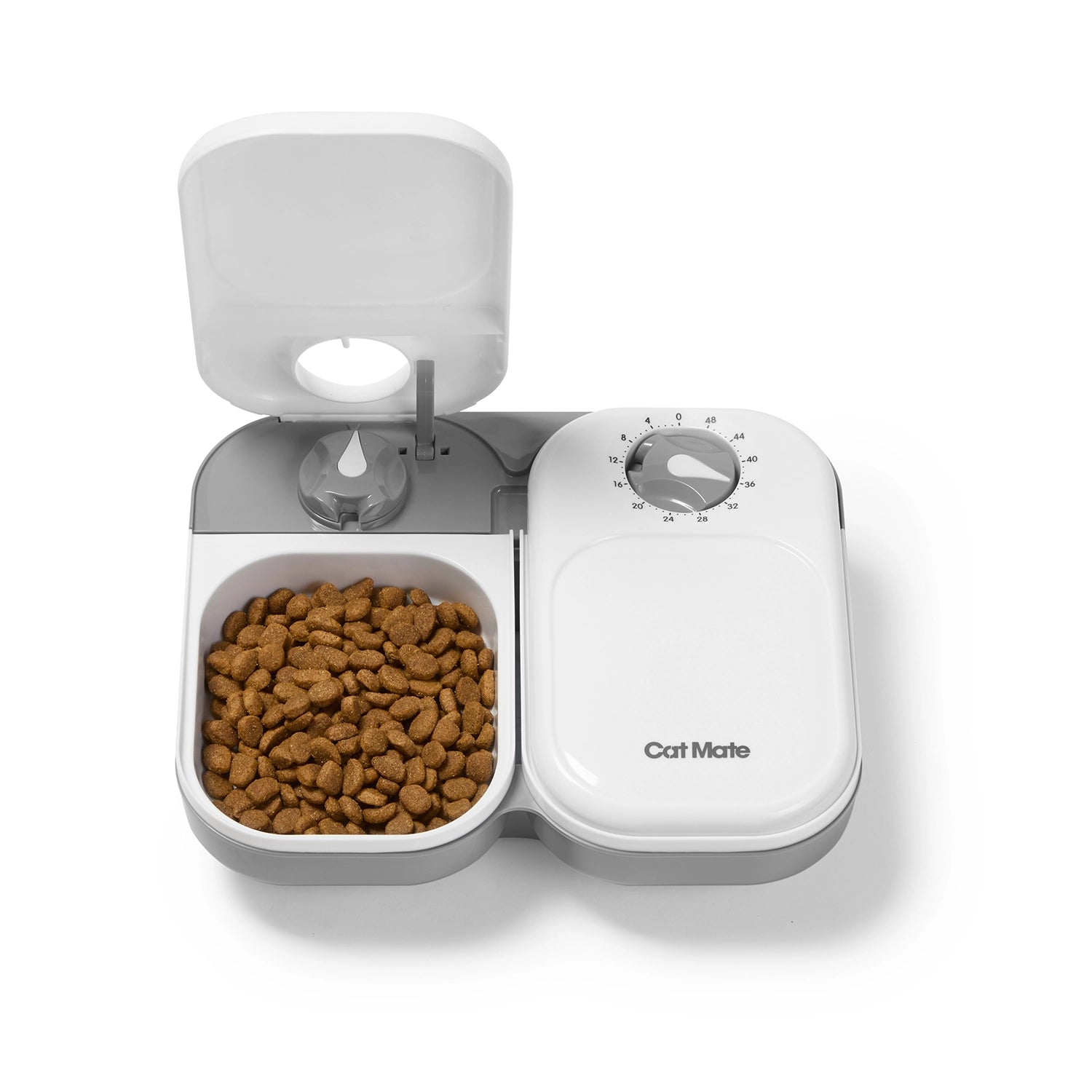 A two meal automatic pet feeder with dry pet food inside one bowl, while the adjacent bowl is in the closed positron with an active timer on a white background