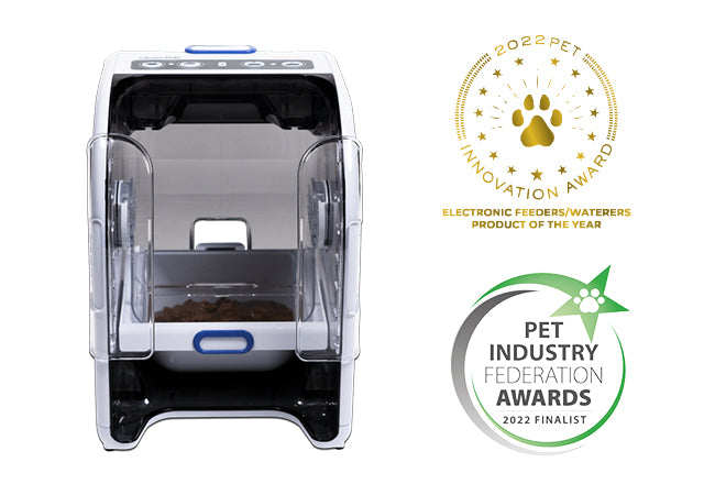 Automatic microchip pet feeder with a transparent container and black base, labelled as 'Electronics Product of the Year' and 'Pet Industry Innovation Awards 2022 Finalist'.