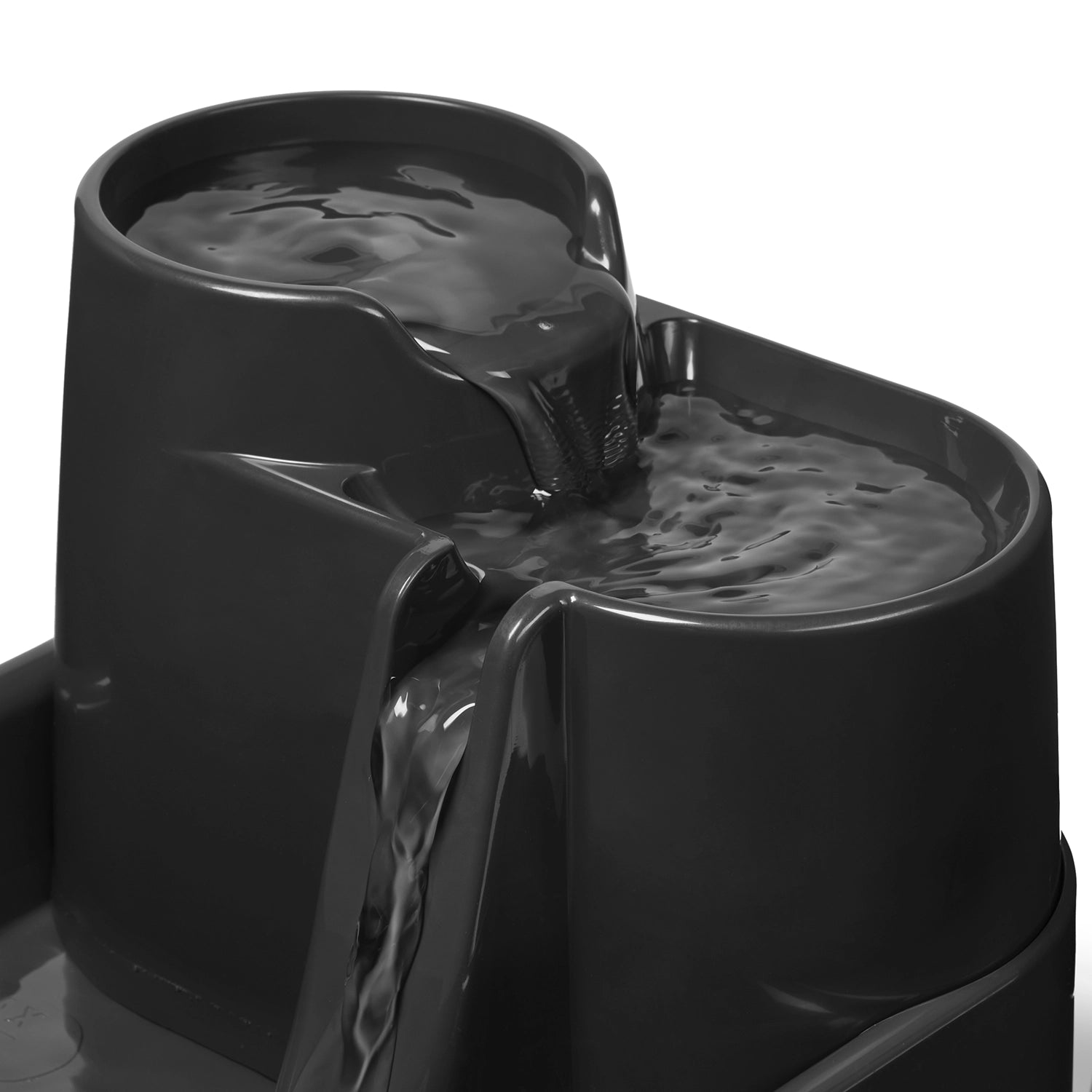 A close up view of water flowing down the grey water fountain made by Cat Mate on a white background 