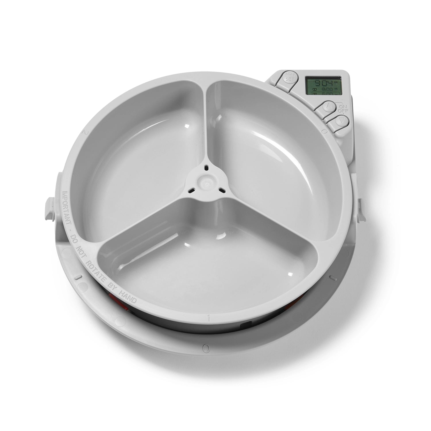 A Pet food dispenser with three empty bowls with a digital timer display on a white background